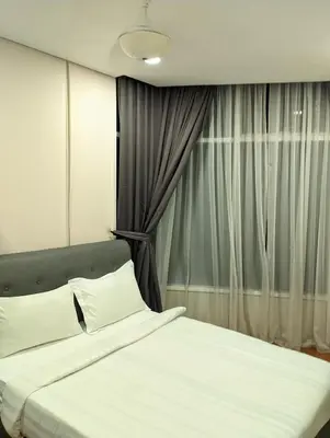 a bedroom with a white bed with a window at Luxury Home Stay by FNF suites in Kuala Lumpur