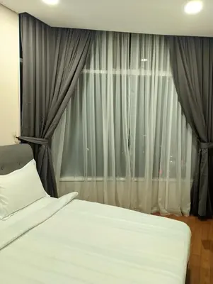 a bedroom with a white bed and a window at Luxury Home Stay by FNF suites in Kuala Lumpur