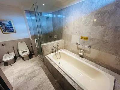 a bathroom with a toilet and a tub and a sink at Holiday Residence at times square kL in Kuala Lumpur
