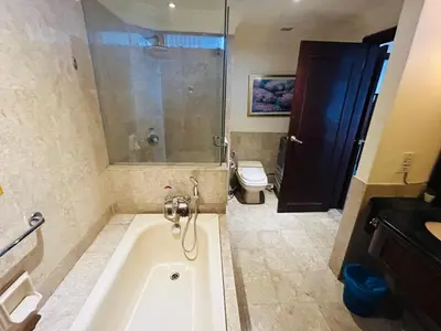 a bathroom with a bath tub and a toilet at Holiday Residence at times square kL in Kuala Lumpur