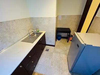 a small kitchen with a sink and a refrigerator at Holiday Residence at times square kL in Kuala Lumpur