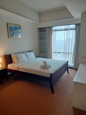 a bedroom with a bed with a teddy bear on it at Homestay suite at times square KL in Kuala Lumpur