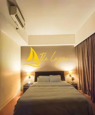 a bedroom with a bed with a yellow sign on the wall at Central 1BR Merdeka 118 View in Kuala Lumpur