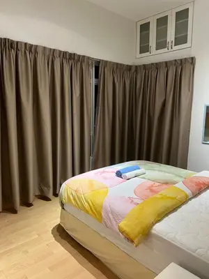 a bed sitting in a room with a window at Seri bukit ceylon kl in Kuala Lumpur