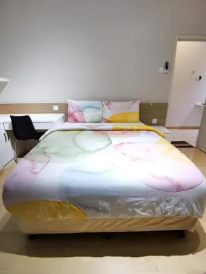 a large bed sitting in a room with at Seri bukit ceylon kl in Kuala Lumpur