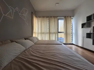 a large bed in a room with a large window at Regalia Residence KLCC By Rainbow in Kuala Lumpur