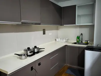 a kitchen with a stove and a counter top at Regalia Residence KLCC By Rainbow in Kuala Lumpur
