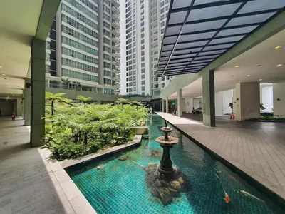 a lobby with a fountain in the middle of a building at Regalia residence suite view in Kuala Lumpur