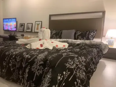 a large bed with a black and white comforter at 28 Boulevard - Pandan Perdana Cheras KL in Kuala Lumpur