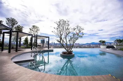 a swimming pool with a tree in the middle of it at 28 Boulevard - Pandan Perdana Cheras KL in Kuala Lumpur