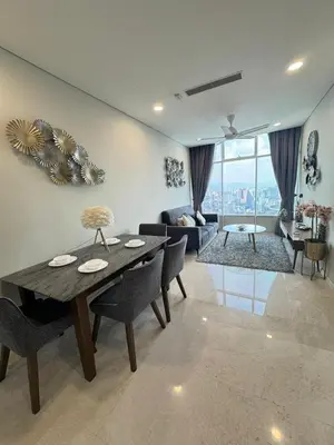 a living room with a table and a couch at Nest In The Sky in Kuala Lumpur