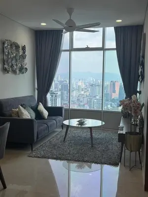 a living room with a couch and a table at Nest In The Sky in Kuala Lumpur