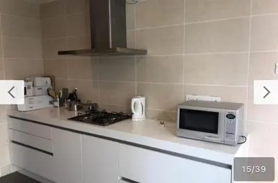 a kitchen with a stove and a microwave on a counter at Avenue K in Kuala Lumpur