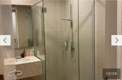 a bathroom with a shower with a sink and a mirror at Avenue K in Kuala Lumpur