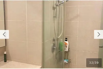 a shower with a glass door in a bathroom at Avenue K in Kuala Lumpur