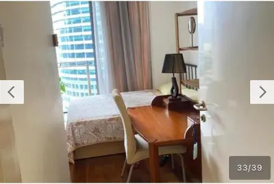 a bedroom with a desk and a bed with a window at Avenue K in Kuala Lumpur
