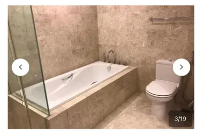 a bathroom with a bath tub and a toilet at Avenue K in Kuala Lumpur