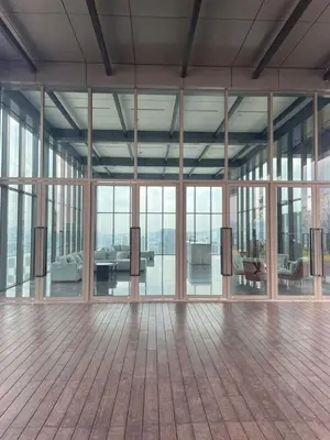 a large room with glass doors and a wooden floor at COZY Kenwingston platz KL 2-5PAX Klcc View Pakin Nefix Free parkin 1807 in Kuala Lumpur