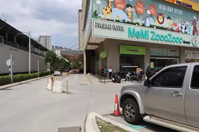 a silver truck parked in front of a store at COZY Kenwingston platz KL 2-5PAX Klcc View Pakin Nefix Free parkin 1807 in Kuala Lumpur