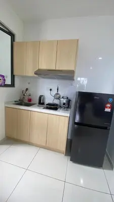 a kitchen with a black refrigerator and wooden cabinets at COZY Kenwingston platz KL 2-5PAX Klcc View Pakin Nefix Free parkin 1807 in Kuala Lumpur