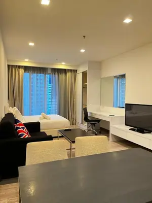 a living room with a couch and a bed and a television at Flexy Suite at One Bukit Ceylon Bukit Bintang in Kuala Lumpur