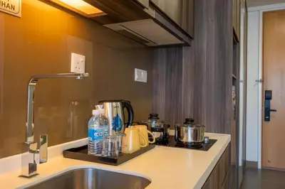 a kitchen with a sink and a counter top with pots and pans at Flexy Suite at One Bukit Ceylon Bukit Bintang in Kuala Lumpur