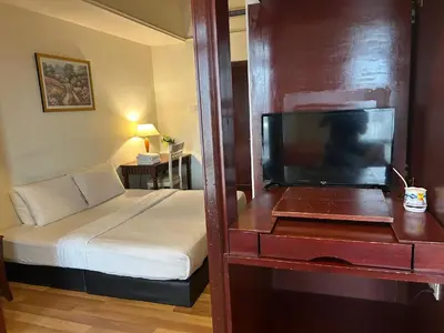 a bedroom with a bed and a dresser with a television at My Residence suite at Berjaya times square Kl in Kuala Lumpur