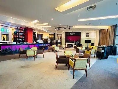 a hotel lobby with tables and chairs and a bar at My Residence suite at Berjaya times square Kl in Kuala Lumpur