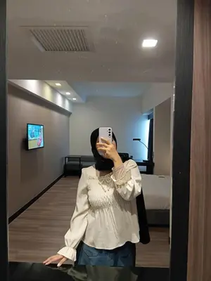 a woman taking a picture of herself in a mirror at Politeknik metro kl in Kuala Lumpur