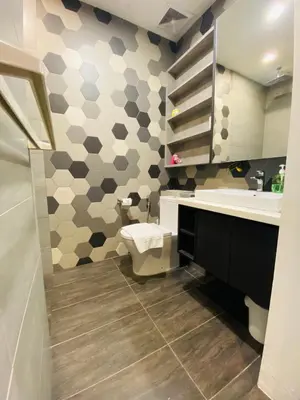 a bathroom with a toilet and a sink at Ceylonz Suites by Stayla in Kuala Lumpur