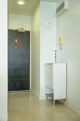 a white bathroom with a cross on the wall at A Cozy & Comfy Studio in KLCC with KL Tower View in Kuala Lumpur