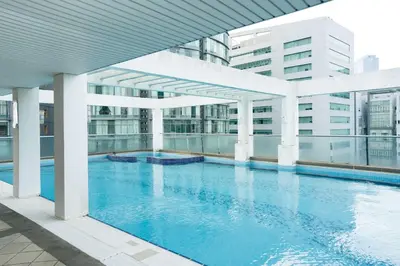 a large swimming pool on the side of a building at A Cozy & Comfy Studio in KLCC with KL Tower View in Kuala Lumpur