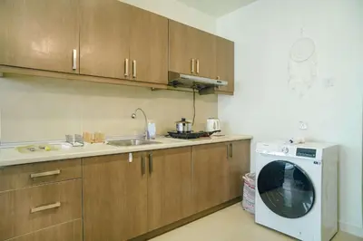 a kitchen with a sink and a washing machine at A Cozy & Comfy Studio in KLCC with KL Tower View in Kuala Lumpur