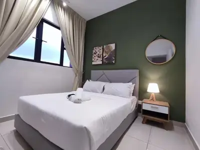 a bedroom with a large white bed and a window at Trion KL at Level 57 in Kuala Lumpur