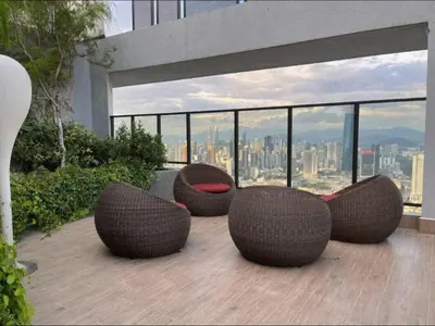 a balcony with two seats and a view of a city at Trion KL at Level 57 in Kuala Lumpur