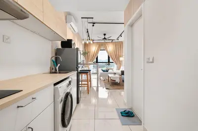 a kitchen with a washer and dryer at Muji Studio Continew by RumaBnB in Kuala Lumpur