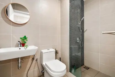 a bathroom with a toilet and a sink and a shower at Muji Studio Continew by RumaBnB in Kuala Lumpur