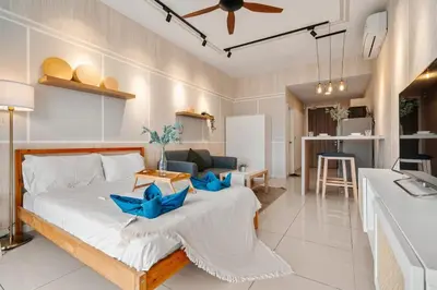 a bedroom with a bed and a living room at Muji Studio Continew by RumaBnB in Kuala Lumpur