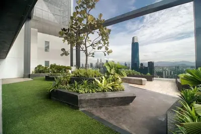 a rooftop garden with a view of the city at Muji Studio Continew by RumaBnB in Kuala Lumpur