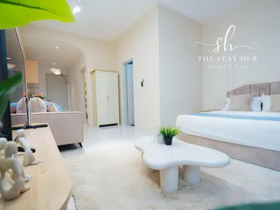 a white bedroom with a bed and a white table at Majestic Residence - Central KL Stay with Petronas Twin Towers View Sky Pool by The Stay Hub in Kuala Lumpur