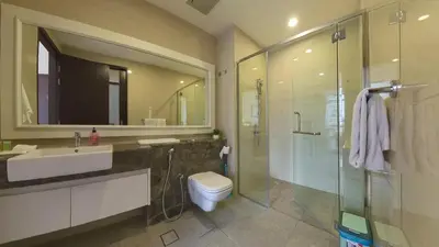 a bathroom with a sink and a toilet and a shower at Manor Residence KLCC - LV Home in Kuala Lumpur