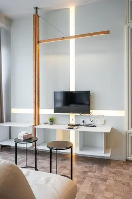 a living room with a tv on a white shelf at KLCC Expressionz Couple Suites 1B1B in Kuala Lumpur