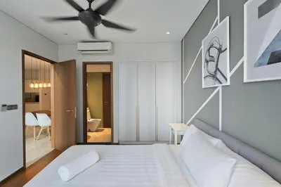 a bedroom with a bed and a ceiling fan at Sky Suites KLCC - Luxury Service Apartments Near Petronas Twin Tower in Kuala Lumpur