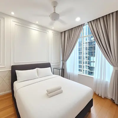 a bedroom with a white bed and a large window at Sky Suites KLCC - Luxury Service Apartments Near Petronas Twin Tower in Kuala Lumpur