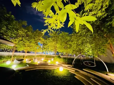 a garden at night with a pond and lights at Scarletz Villa Near By KLCC in Kuala Lumpur