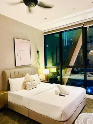 a bedroom with a large bed and a large window at Scarletz Villa Near By KLCC in Kuala Lumpur