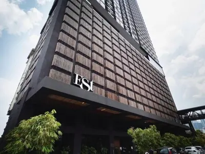 a tall building with the rst sign on it at Mindful Bangsar Loft KL Sentral Mid Valley The Gardens Pasar Seni in Kuala Lumpur