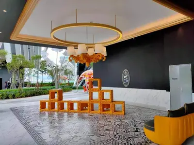 a living room with a table and chairs and a chandelier at ARTE Mont Kiara Designer Suites by HOST CORNER in Kuala Lumpur