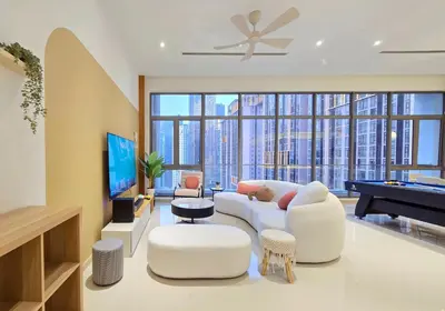 a living room with a white couch and a piano at KL Penthouse Skyline View in Bukit Bintang Fairlane in Kuala Lumpur