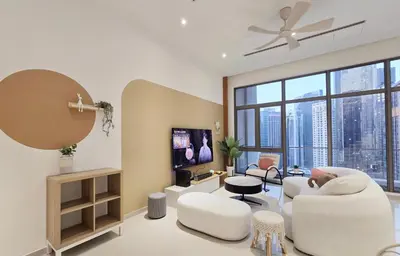 a living room with white furniture and a large window at KL Penthouse Skyline View in Bukit Bintang Fairlane in Kuala Lumpur